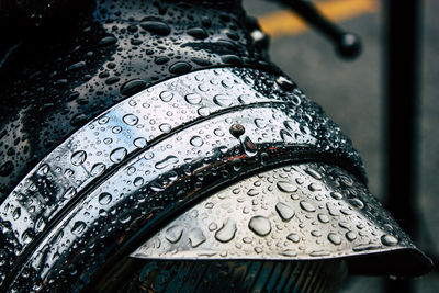 Close-up of wet headlight during rainy season