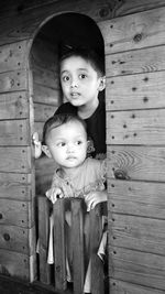 Brother and sister at entrance of playhouse