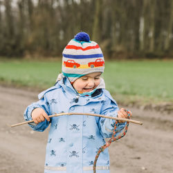 Full length of a boy holding umbrella