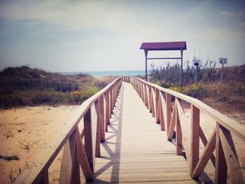 View of boardwalk leading towards sea