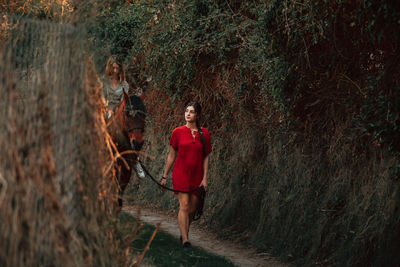 Women with horse in forest