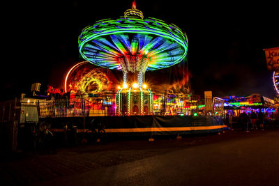 Illuminated ferris wheel at night