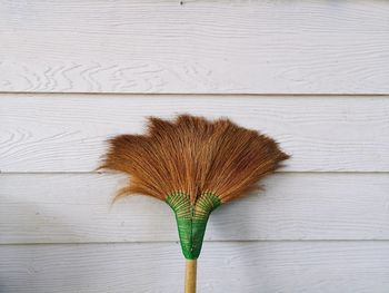 Close-up of broom on wall