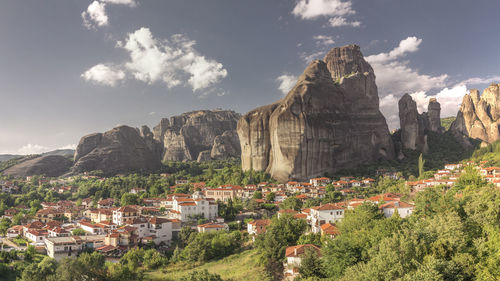 Panoramic view of townscape and mountains against sky