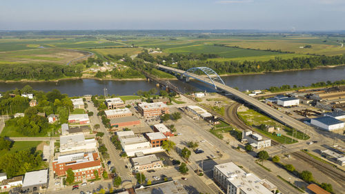 High angle view of river amidst city against sky