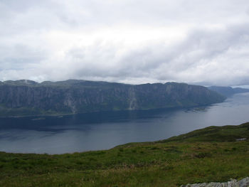 Scenic view of lake and mountains against sky