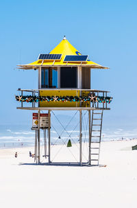 Lifeguard hut on beach against clear sky