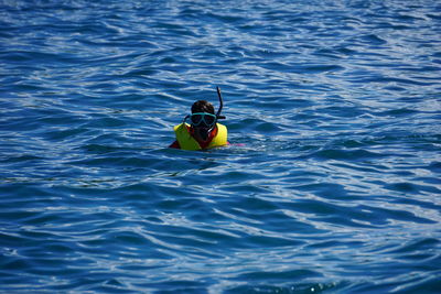 High angle view of woman swimming in sea