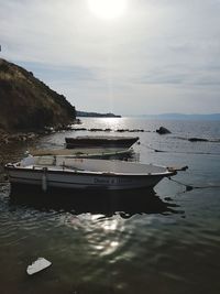 Ship moored on sea against sky