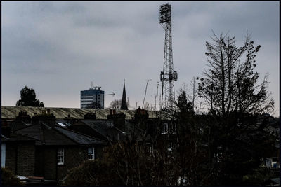 Low angle view of trees and buildings against sky