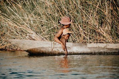 Full length of shirtless man in lake