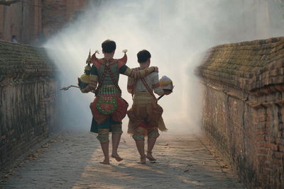 Rear view of couple walking outdoors