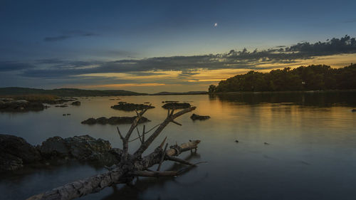 Scenic view of lake against sky during sunset