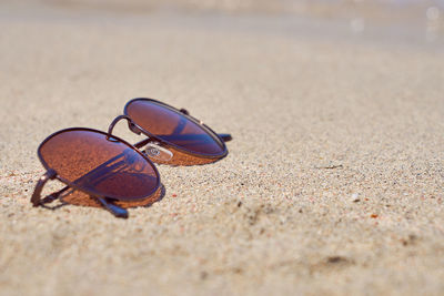 Close-up of shoes on sand
