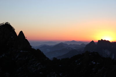 Scenic view of mountains against sky during sunrise 