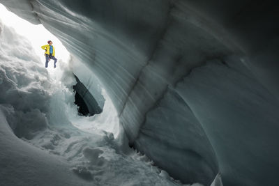 Mountain climber, paul mcsorley, seen through glacial crevasse.