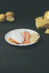 Close-up of cake on table against black background