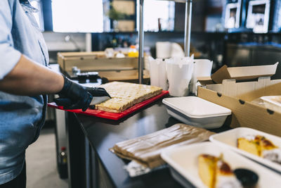 Midsection of man preparing food in kitchen