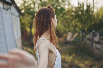 Rear view of woman standing outdoors