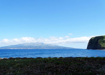 Scenic view of sea against blue sky