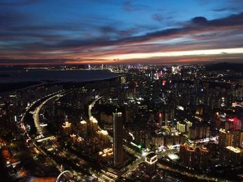 High angle view of illuminated city against sky at night