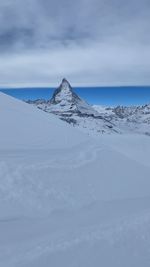 Scenic view of snowcapped mountain against sky