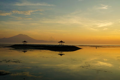 Scenic view of beach against sky during sunset