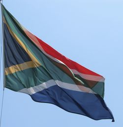 Low angle view of flag against clear sky