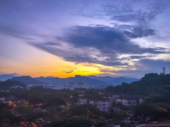 Scenic view of silhouette mountains against sky at sunset