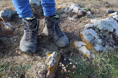 Low section of person standing in mud