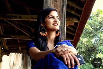 Portrait of happy young woman looking away