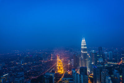 Aerial view of city lit up at night