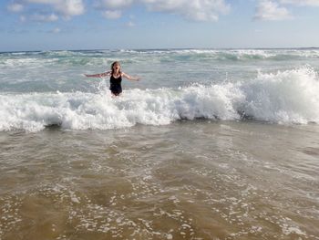 Man in sea against sky