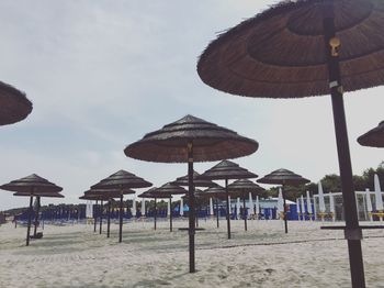 Sunshades on beach against sky