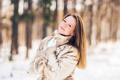 Portrait of young woman in snow