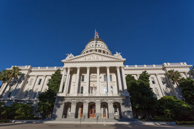 Low angle view of historical building against blue sky