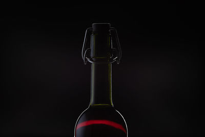 Close-up of beer bottle against black background