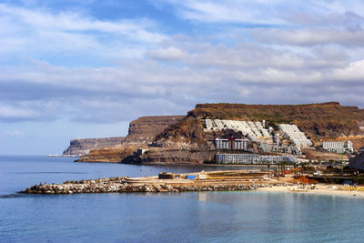 Building by sea against sky