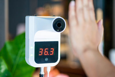 Close-up of hand holding clock