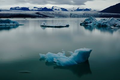 Scenic view of frozen lake against sky