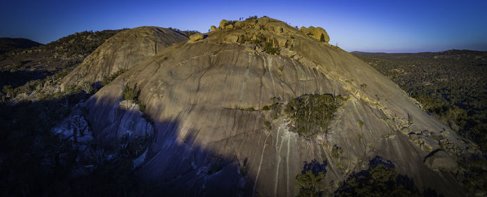 Panoramic view of rocky mountains against clear sky