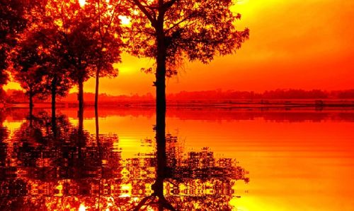 Scenic view of lake against orange sky
