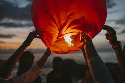 People celebrating setting off fire lanterns.