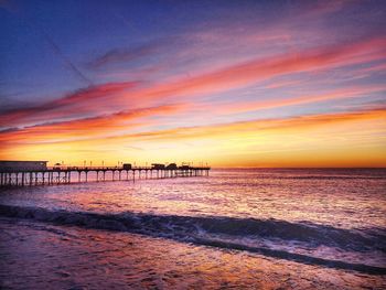 Scenic view of beach against sky during sunset