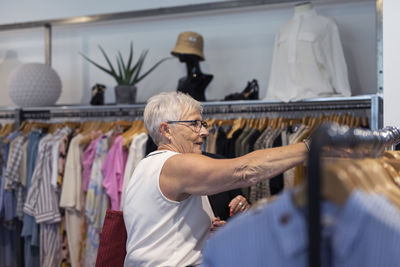 Senior woman doing shopping in clothes shop