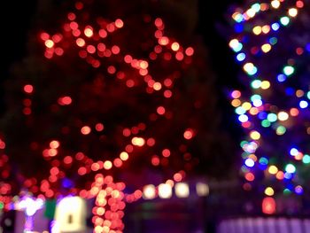 Defocused image of illuminated christmas tree at night