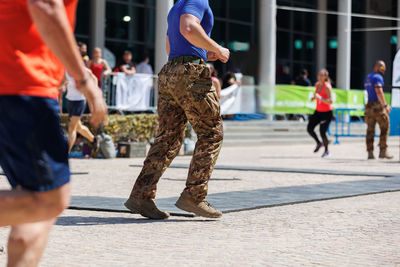 Low section of people walking on street