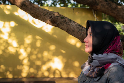 Midsection of woman sitting outdoors