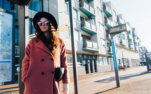 Woman standing at tram stop