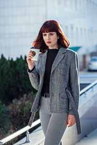 Portrait of beautiful young woman standing outdoors